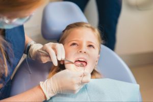 A child is receiving a dental checkup