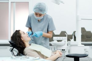 A lady lying on the dental patient chair for a dental health checkup.