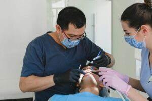 Dentist and a nurse conducting scaling and polishing process.