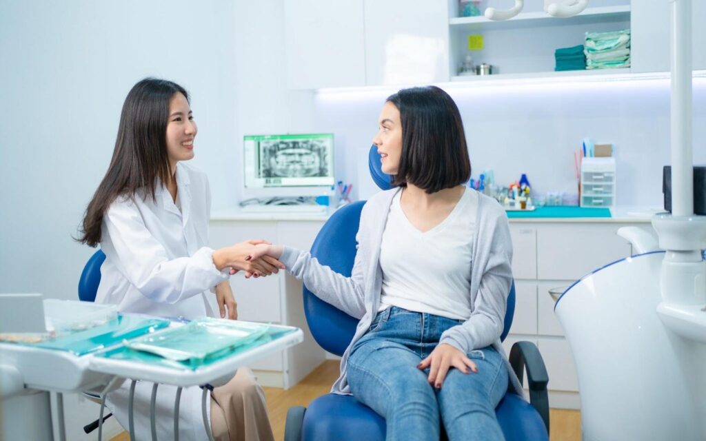 lady shaking hands with a female dentist